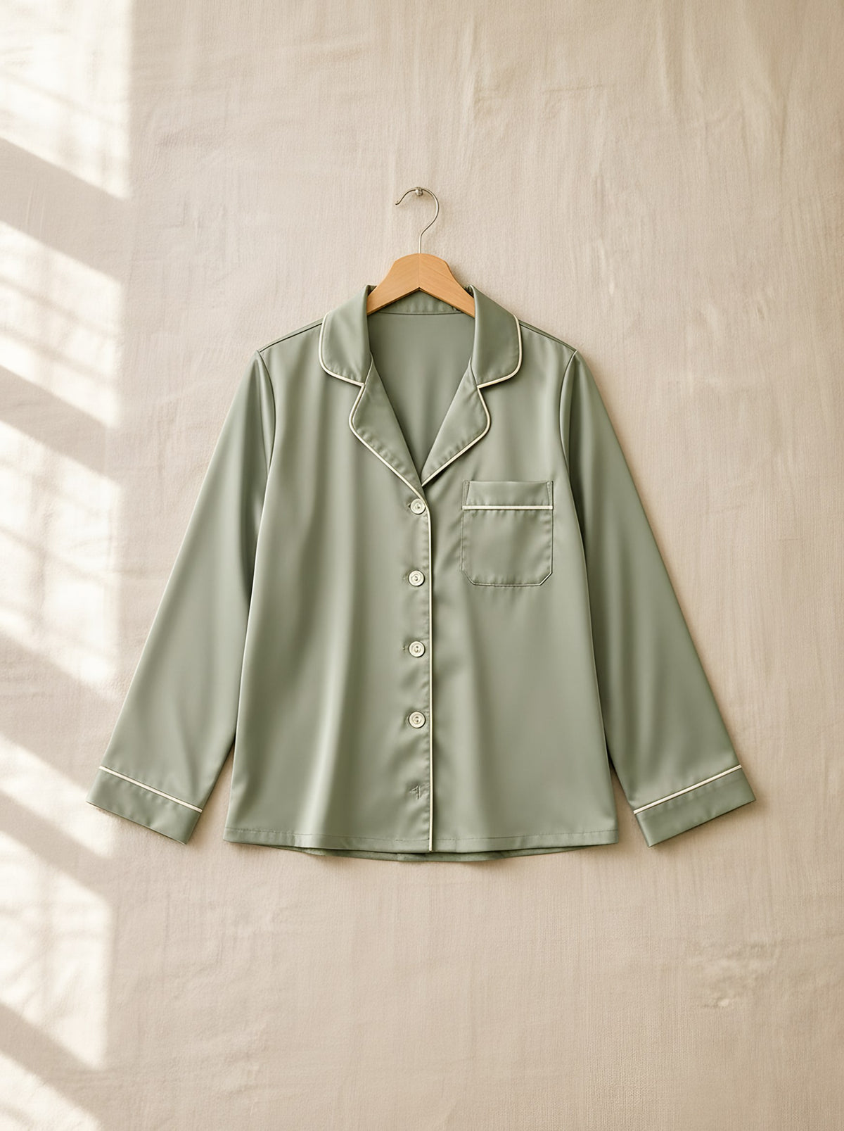 Henrietta satin pyjamas, front view on a wooden hanger, Cedar Atelier