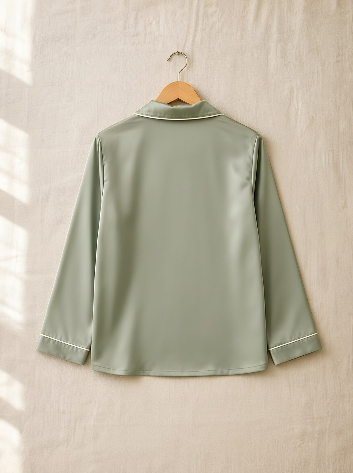 Henrietta satin pyjamas, back view on a wooden hanger, Cedar Atelier