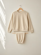 Marigold warm fleece pyjamas, front view on a wooden hanger, Cedar Atelier