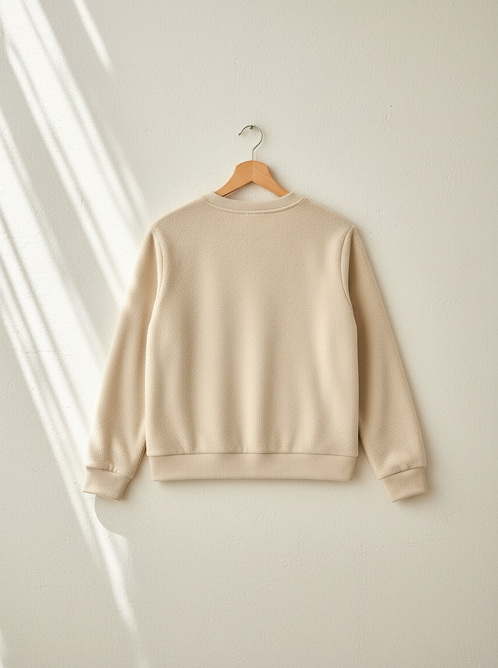 Marigold warm fleece pyjamas, back view on a wooden hanger, Cedar Atelier