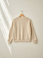 Marigold warm fleece pyjamas, back view on a wooden hanger, Cedar Atelier
